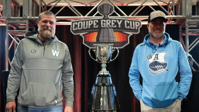 Winnipeg Blue Bombers Head Coach Mike O'Shea, left, and Toronto Argonauts Head Coach Ryan Dinwiddie, right, pose for a photo during a news conference ahead of the 111th CFL Grey Cup, in Vancouver, B.C., Tuesday, Nov. 12, 2024. (CP/ Ethan Cairns)