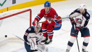 Montreal Canadiens' Juraj Slafkovsky (20) jumps in front of Columbus Blue Jackets goaltender Daniil Tarasov (40) as teammate Mike Matheson (not shown) scores during first period NHL hockey action in Montreal, Saturday, Nov. 16, 2024. (Christinne Muschi/CP)