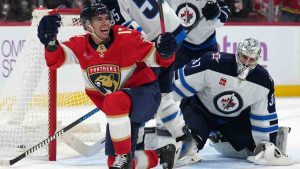 Florida Panthers centre Evan Rodrigues, left, reacts after scoring against Winnipeg Jets goaltender Connor Hellebuyck, right, during the second period of an NHL hockey game, Saturday, Nov. 16, 2024, in Sunrise, Fla. (Lynne Sladky/AP)