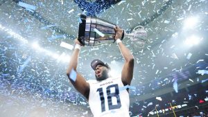 Toronto Argonauts' Dejon Brissett (18) lifts the Grey Cup after defeating the Winnipeg Blue Bombers in CFL football action at the 111th Grey Cup in Vancouver on Sunday, November 17, 2024. (Nathan Denette/CP)