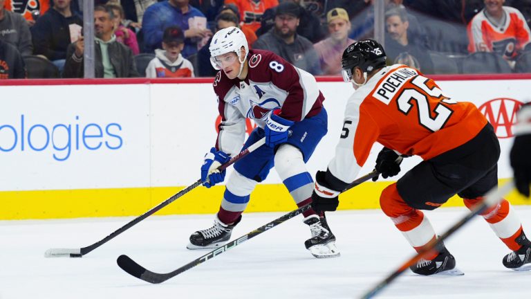 Colorado Avalanche's Cale Makar, left, looks to take a shot past Philadelphia Flyers' Ryan Poehling (25) during the first period of an NHL hockey game, Monday, Nov. 18, 2024, in Philadelphia. (AP Photo/Derik Hamilton)