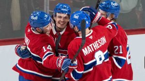 Montreal Canadiens' Jake Evans (71) celebrates his empty net goal with teammates Nick Suzuki (14), Kaiden Guhle (21) and Mike Matheson (8) during third period NHL hockey action in Montreal, Monday, Nov. 18, 2024. (Christinne Muschi/CP)