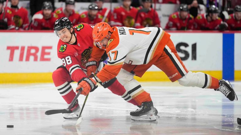 Chicago Blackhawks center Connor Bedard, left, and Anaheim Ducks left wing Alex Killorn fight for control of the puck during the second period of an NHL hockey game Tuesday, Nov. 19, 2024, in Chicago. (AP Photo/Erin Hooley)