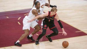 Toronto Raptors' Gradey Dick (1) keeps the ball from Cleveland Cavaliers' Isaac Okoro, left, as Cavaliers' Craig Porter Jr. (9) watches during the first half of an NBA basketball game in Cleveland, Sunday, Nov 24, 2024. (Phil Long/AP)