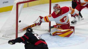 Ottawa Senators right wing Adam Gaudette fires the puck past Calgary Flames goaltender Dustin Wolf to score during first period NHL action on Monday, November 25, 2024 in Ottawa. (Adrian Wyld/CP)