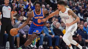 New York Knicks forward OG Anunoby drives past Denver Nuggets forward Michael Porter Jr. in the first half of an NBA basketball game Monday, Nov. 25, 2024, in Denver. (David Zalubowski/AP)