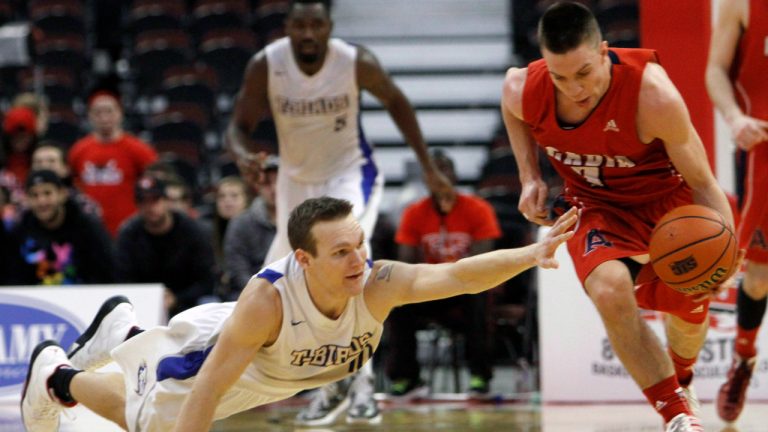 Sean Stoqua (7) drives down the court at the Canadian Interuniversity Sport Basketball final 8, in Ottawa, Friday, March 8, 2013. THE CANADIAN PRESS/Fred Chartrand