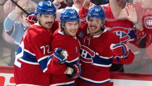 Montreal Canadiens' Jake Evans, centre, celebrates his goal over Columbus Blue Jackets with teammates Arber Xhekaj (72) and Alex Newhook (15) during third period NHL hockey action in Montreal, Saturday, Nov. 16, 2024.  (Christinne Muschi/CP)