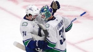 Vancouver Canucks goaltender Kevin Lankinen (32) is congratulated by Jake DeBrusk after shutting out the Boston Bruins 2-0 after an NHL hockey game, Tuesday, Nov. 26, 2024, in Boston. (Charles Krupa/AP)