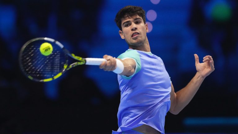 Spain's Carlos Alcaraz returns the ball to Denmark's Casper Ruud during their singles tennis match of the ATP World Tour Finals at the Inalpi Arena, in Turin, Italy, Monday, Nov. 11, 2024. (Antonio Calanni/AP)