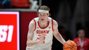 Utah centre Branden Carlson brings the ball up court during the second half of an NCAA college basketball game against Stanford. (Rick Bowmer/AP)