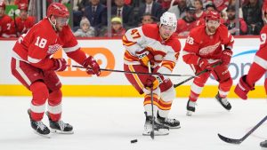 Calgary Flames centre Connor Zary reaches for the pass during the third period of an NHL game against the Detroit Red Wings, Wednesday, Nov. 27, 2024, in Detroit. (AP/Carlos Osorio)