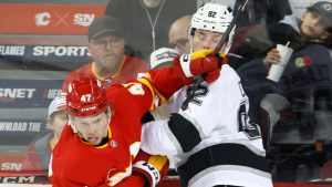 Los Angeles Kings' Brandt Clarke (92) battles with Calgary Flames' Connor Zary during second period NHL hockey action in Calgary, Alta., Monday, Nov. 11, 2024. (Larry MacDougal/CP)