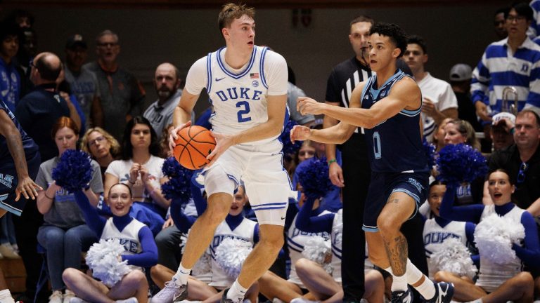 Duke's Cooper Flagg (2) handles the ball as Maine's Logan Carey (0) defends during the first half of an NCAA college basketball game in Durham, N.C., Monday, Nov. 4, 2024. (AP Photo/Ben McKeown)