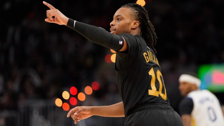 Cleveland Cavaliers guard Darius Garland (10) gestures after hitting a three-point basket in the second half of an NBA basketball game against the Golden State Warriors, Friday, Nov. 8, 2024, in Cleveland. (AP Photo/Sue Ogrocki)