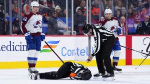 Referee Mitch Dunning, bottom, lies on the ice after an injury during the first period of an NHL hockey game between the Philadelphia Flyers and the Colorado Avalanche, Monday, Nov. 18, 2024, in Philadelphia. (Derik Hamilton/AP)