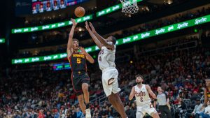 Atlanta Hawks guard Dyson Daniels (5) attempts a basket against Cleveland Cavaliers forward Evan Mobley (4) during the second half of an Emirates NBA Cup basketball game. (Erik Rank/AP)