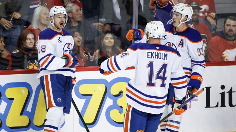 Edmonton Oilers' Zach Hyman, left, celebrates his goal with teammates uring third period NHL hockey action against the Calgary Flames in Calgary on Sunday, Nov. 3, 2024. (Jeff McIntosh/CP)