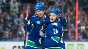 Vancouver Canucks' Erik Brannstrom (right) celebrates with teammate Elias Pettersson after scoring a goal against the Calgary Flames during third period NHL action in Vancouver, B.C., Tuesday, November 12, 2024. (CP)