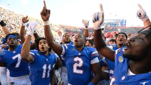 Florida quarterback DJ Lagway (2) and teammates Trikweze Bridges (7), Aidan Mizell (11) and Jadan Baugh (13) celebrate their 24-17 win against Mississippi in an NCAA college football game, Saturday, Nov. 23, 2024, in Gainesville, Fla. (AP/Phelan M. Ebenhack)