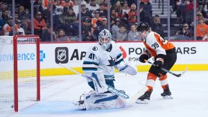 Philadelphia Flyers' Matvei Michkov, right, scores a goal against San Jose Sharks' Vitek Vanecek during the second period of an NHL hockey game, Monday, Nov. 11, 2024, in Philadelphia. (AP Photo/Matt Slocum)