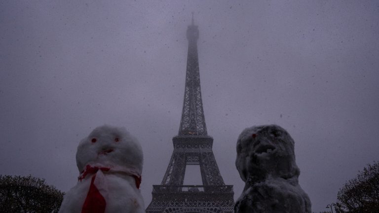 Snow figures are seen near to the Eiffel Tower as snow falls in Paris, Thursday, Nov. 21, 2024. (AP/Louise Delmotte)