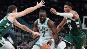 Boston Celtics' Jaylen Brown drives between Milwaukee Bucks' Pat Connaughton and Giannis Antetokounmpo during the first half of an NBA basketball game Sunday, Nov. 10, 2024, in Milwaukee. (Morry Gash/AP)