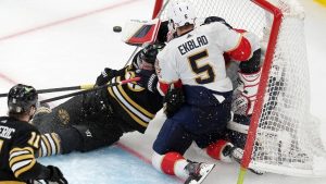 Boston Bruins' Jakub Lauko (94) collides with Florida Panthers' Sergei Bobrovsky, back right, and is called for goalie interference as Panthers' Aaron Ekblad (5) defends. (AP Photo/Michael Dwyer)