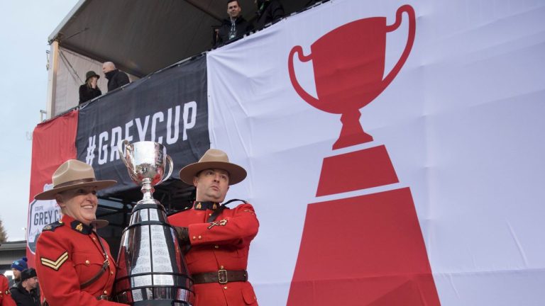 Members of the RCMP carry the Grey Cup into the stadium prior to the 107th Grey Cup in Calgary, Alta. (Todd Korol/CP Photo)