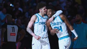 Charlotte Hornets guard LaMelo Ball (1) and forward Brandon Miller (24) embrace after winning an NBA basketball game against the Detroit Pistons, Wednesday, Nov. 6, 2024, in Charlotte, N.C. (AP Photo/Matt Kelley)