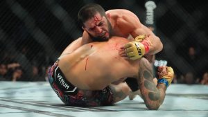 Islam Makhachev grapples with Dustin Poirier during the fifth round of their lightweight title bout at UFC 302. (Frank Franklin II/AP)