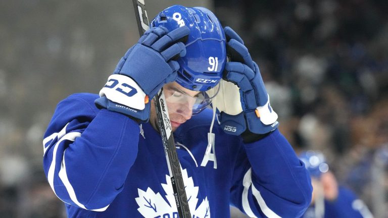 Toronto Maple Leafs' John Tavares puts on his helmet before NHL hockey action against the Ottawa Senators in Toronto, on Tuesday, November 12, 2024. (Chris Young/CP)