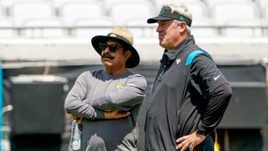 Jacksonville Jaguars owner Shad Khan, left, and head coach Doug Pederson watch players perform drills at an NFL football practice, Monday, June 13, 2022, in Jacksonville, Fla. (AP Photo/John Raoux)