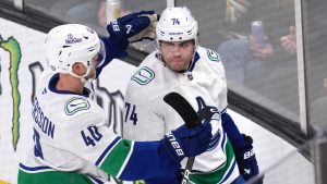 Vancouver Canucks left winger Jake DeBrusk is congratulated by Elias Pettersson after his goal against Boston Bruins goaltender Jeremy Swayman during the second period of an NHL game, Tuesday, Nov. 26, 2024, in Boston. (AP/Charles Krupa)