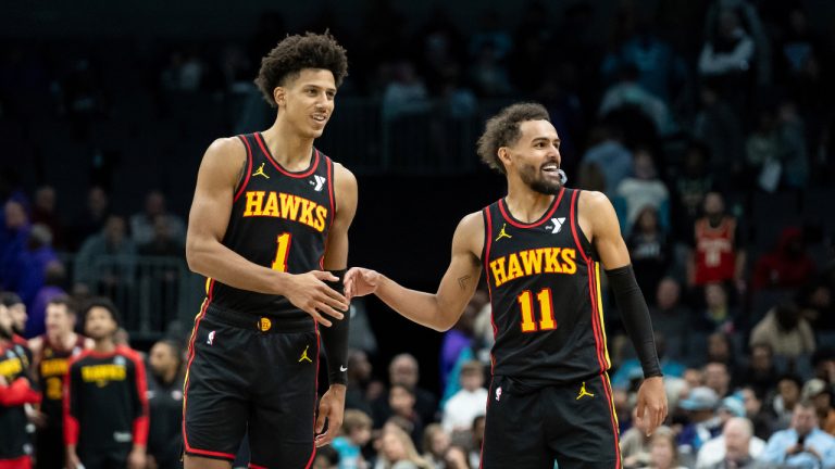 Atlanta Hawks forward Jalen Johnson (1) and guard Trae Young (11) high-five during the second half of an NBA basketball game against the Charlotte Hornets. (Matt Kelley/AP)