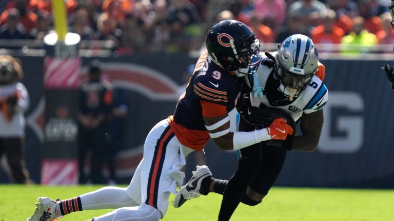 Chicago Bears safety Jaquan Brisker (9) tackles Carolina Panthers wide receiver Diontae Johnson (5) during the first half of an NFL football game Sunday, Oct. 6, 2024, in Chicago. (AP Photo/Nam Y. Huh)