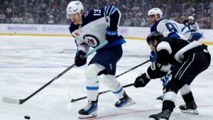 Winnipeg Jets centre Gabriel Vilardi, left, controls the puck past Los Angeles Kings right wing Adrian Kempe during the second period of an NHL hockey game Wednesday, Nov. 27, 2024, in Los Angeles. (Ryan Sun/AP)