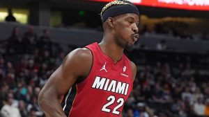 Miami Heat forward Jimmy Butler reacts after falling on the floor while driving the lane in the first half of an NBA basketball game against the Denver Nuggets, Friday, Nov. 8, 2024, in Denver. (AP Photo/David Zalubowski)