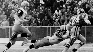 Saskatchewan’s Bob Kosid (24) is tackled by Allan Smith (22) of the Tiger-Cats, while Hamilton quarterback Joe Zuger gives pursuit after Kosid intercepted a Zuger pass during the Grey Cup game in Ottawa, Dec. 2, 1967. THE CANADIAN PRESS