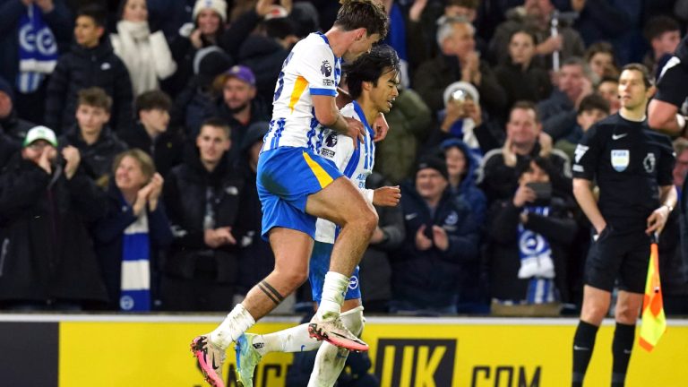 Brighton and Hove Albion's Kaoru Mitoma, right, celebrates scoring during the Englidh Premier League soccer match. (Gareth Fuller/PA via AP)