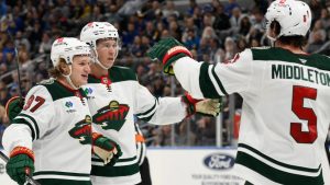 Minnesota Wild left wing Kirill Kaprizov, left, celebrates with teammates left wing Matt Boldy, center, and defenseman Jake Middleton (5) after scoring a goal against the St. Louis Blues. (Jeff Le/AP)