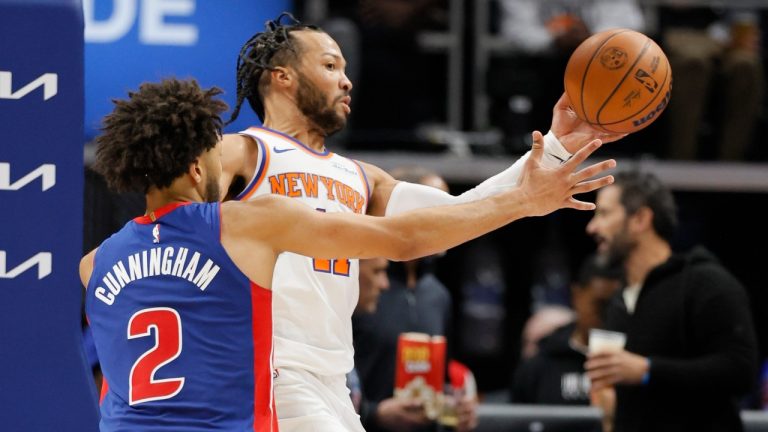 New York Knicks guard Jalen Brunson (11) passes the ball against Detroit Pistons guard Cade Cunningham (2) during the second half of an NBA basketball game Friday, Nov. 1, 2024, in Detroit. (AP Photo/Duane Burleson)