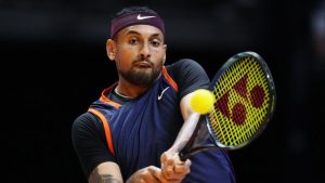 Nick Kyrgios of Eagles returns the ball to Grigor Dimitrov of Falcons during a match of Day 3 of the World Tennis League at Coca-Cola Arena in Dubai, United Arab Emirates, on Dec. 21, 2022. (Kamran Jebreili/AP)
