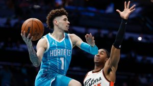 Charlotte Hornets guard LaMelo Ball (1) looks to pass the ball around Detroit Pistons guard Jaden Ivey (23) during the first half of an NBA basketball game in Charlotte, N.C., Thursday, Nov. 21, 2024. (AP Photo/Nell Redmond)