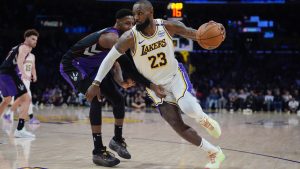 Los Angeles Lakers forward LeBron James (23) is defended by Toronto Raptors guard RJ Barrett during the second half of an NBA basketball game Sunday, Nov. 10, 2024, in Los Angeles. (Marcio Jose Sanchez/AP)