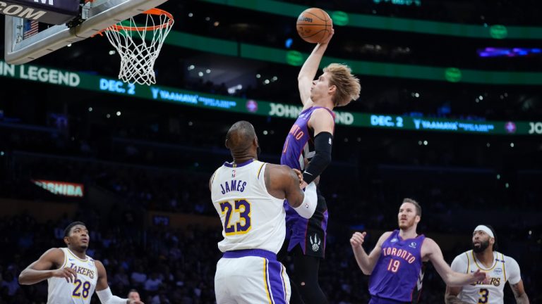 Toronto Raptors guard Gradey Dick drives to the basket past Los Angeles Lakers forward LeBron James (23) during the first half of an NBA basketball game, Sunday, Nov. 10, 2024, in Los Angeles. (Marcio Jose Sanchez/AP)