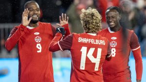 Jacob Shaffelburg (14) is congratulated by Canadian teammates Cyle Larin (9) and midfielder Ismaël Koné after scoring against Suriname in CONCACAF Nations League. (Frank Gunn/CP)