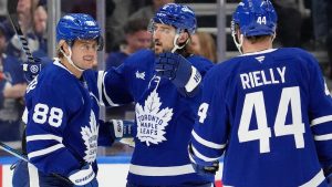 Toronto Maple Leafs right wing William Nylander (88) celebrates his goal with teammates Chris Tanev (8) and Morgan Rielly (44) during first period NHL hockey action against the Tampa Bay Lightning, in Toronto, Monday, Oct. 21, 2024. (Frank Gunn/CP Photo)