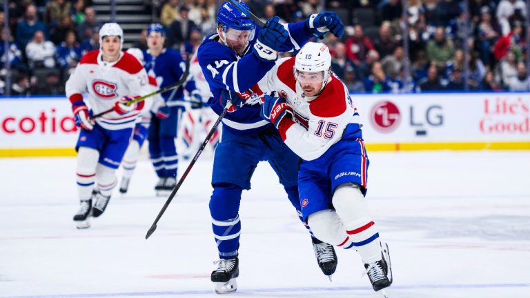 Toronto Maple Leafs' Morgan Rielly (44) and Montreal Canadiens' Alex Newhook (15) race toward the puck, during first period NHL hockey action in Toronto on Saturday, November 9, 2024. (Christopher Katsarov/CP)