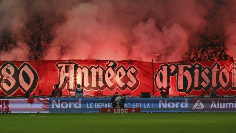 Lille' supporters hold a banner reading " 80 years of history" to celebrate the club's 80th anniversary during the French League One soccer match between Lille and Rennes at the Stade Pierre Mauroy in Villeneuve-d'Ascq, outside Lille, northern France, Sunday, Nov. 24, 2024. (Matthieu Mirville/AP)